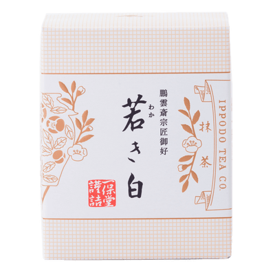Brand new unopened box of Ippodo Tea Co. Wakaki matcha with Japanese characters and gold leaf flowers embossed on white