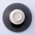 Bottom side of Mino-Yaki dark matcha tea bowl Chawan showing light beige unglazed based and lower portion of bowl