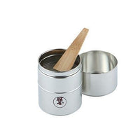Tin matcha sieve (burui) with Ippodo Tea logo on front separated in two pieces with bamboo spatula (takebera) inside
