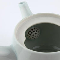 View inside white porcelain Kiyomizu-yaki kyusu teapot showing half dome shaped ceramic strainer with small holes in spout