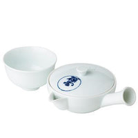 Small white artisan made Kiyomizu-yaki porcelain kyusu teapot with blue Japanese characters on lid beside matching teacup