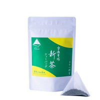One-pot teabag of New Harvest Sencha Tea beside bright green and yellow package of Uji-Shincha sencha one-pot teabags