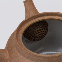 View inside Banko-yaki Yakishime Kyusu ceramic teapot showing interior white glaze and precise domed clay strainer in spout