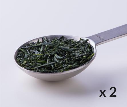 Silver tablespoon filled with dried rolled Ippodo Gyokuro premium Japanese green tea leaves with 