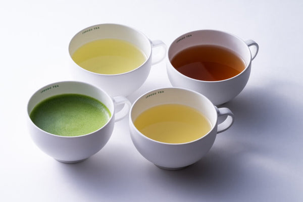 Four white teacups from Ippodo Tea containing different types of tea