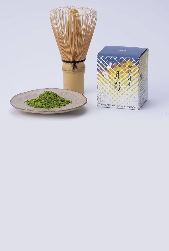 Tsukikage Matcha box with a bowl of whisked matcha and a bamboo whisk
