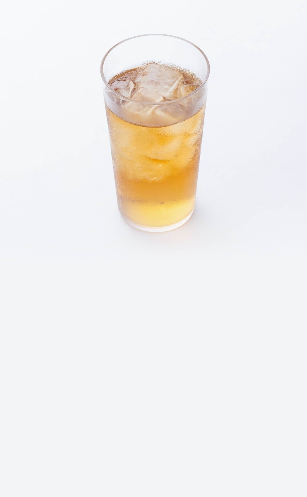 Hojicha 100g on a table with person reading a book