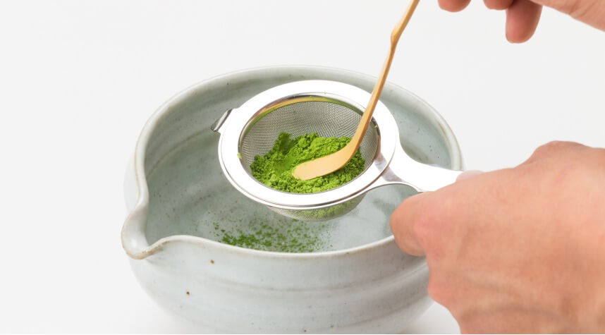 Ippodo Tea - Sifting matcha into a white teabowl with spout