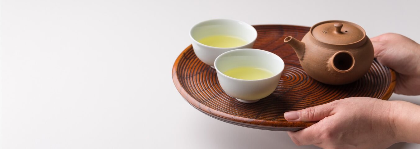Shincha new harvest sencha - brewsed and served on a wooden serving plate.